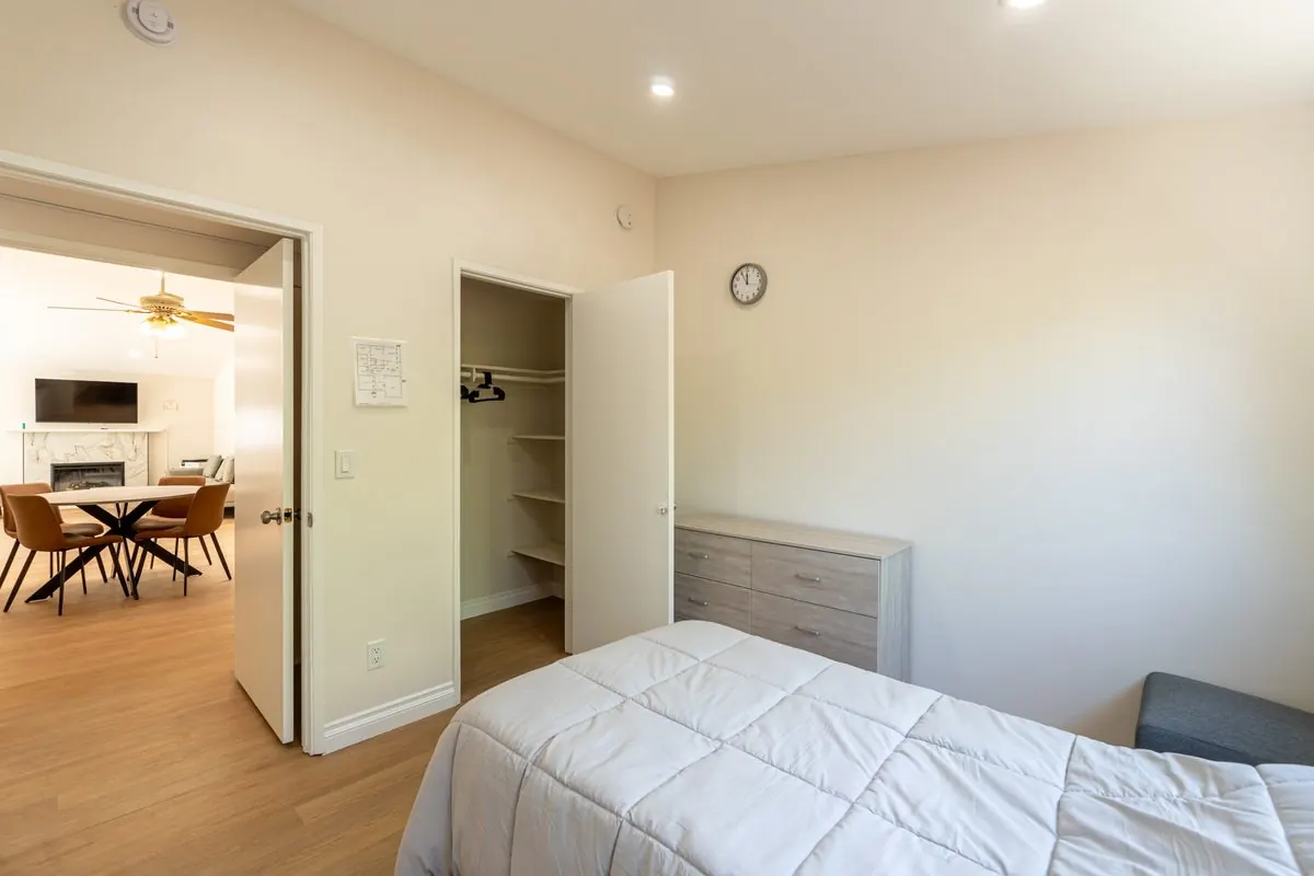 Comfortable resident bedroom opening onto the shared living area