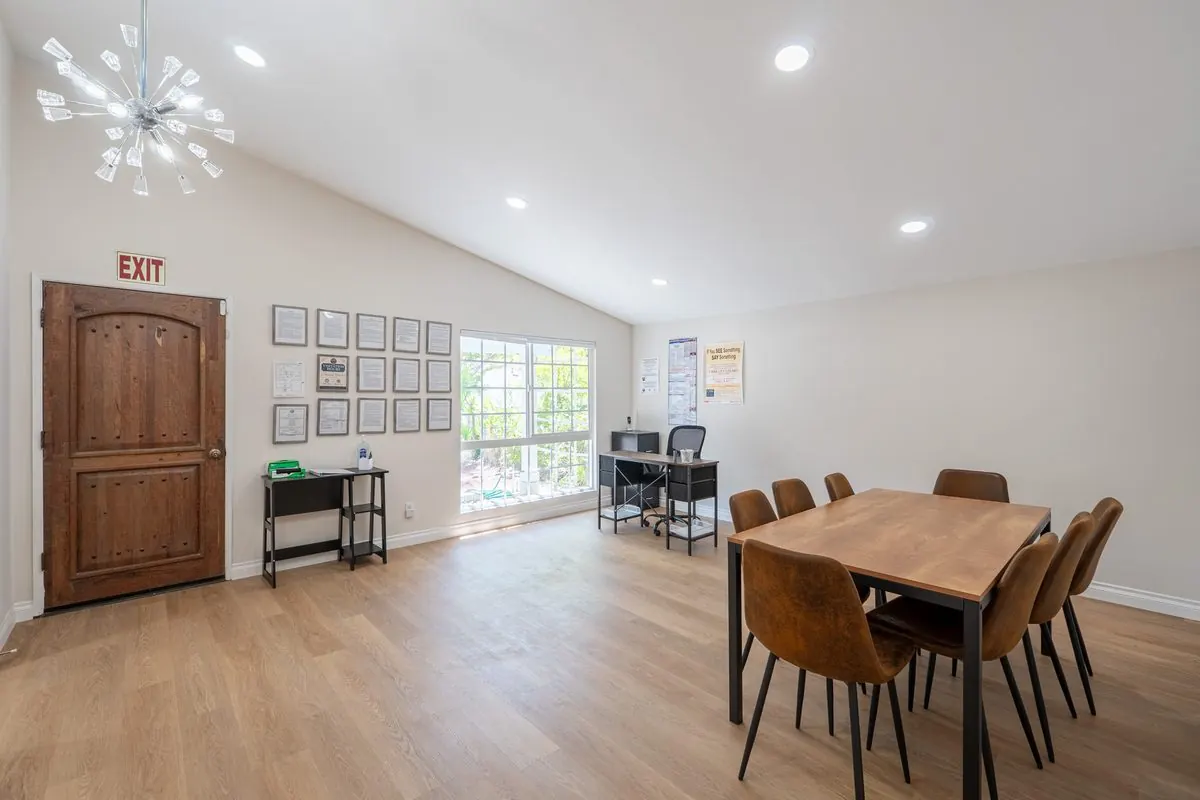 Beautifully furnished common area with dining seating for gatherings